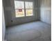 A room with window and cement floor with an electrical outlet at 548 Jocund St # 15, Rolesville, NC 27571