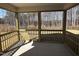 Enclosed porch with wood railings offers view of surrounding trees and yard at 548 Jocund St # 15, Rolesville, NC 27571