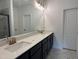 Elegant bathroom featuring a double vanity, stone countertops, and modern fixtures at 564 Jocund St # 11, Rolesville, NC 27571