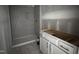 Modern bathroom with a tiled walk-in shower and vanity with gold pulls awaiting finishing touches at 564 Jocund St # 11, Rolesville, NC 27571