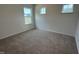 Carpeted bedroom provides natural light through multiple windows at 564 Jocund St # 11, Rolesville, NC 27571
