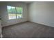 Bright bedroom with a large window, plush carpet, and ample natural light at 564 Jocund St # 11, Rolesville, NC 27571