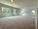 A light-filled bonus room with plush carpeting and multiple windows offering scenic views at 564 Jocund St # 11, Rolesville, NC 27571