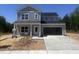 Charming two-story home with gray siding, black roof, inviting front porch, and attached garage at 564 Jocund St # 11, Rolesville, NC 27571