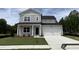 Charming two-story home with a gray exterior, a well-manicured lawn and a two car garage at 564 Jocund St # 11, Rolesville, NC 27571
