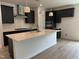 Modern kitchen boasts a large island, stainless steel appliances, and sleek black cabinets at 564 Jocund St # 11, Rolesville, NC 27571