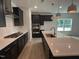 Modern kitchen with sleek black cabinetry, stainless steel appliances, a large island, and stylish pendant lighting at 564 Jocund St # 11, Rolesville, NC 27571