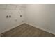 Functional laundry room with wood-look flooring and a wire storage shelf at 564 Jocund St # 11, Rolesville, NC 27571