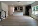 Open-concept living space showcasing hardwood floors, a kitchen, and natural light at 564 Jocund St # 11, Rolesville, NC 27571