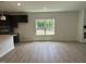 Light-filled living area with hardwood floors, a window, and views of the outdoor scenery at 564 Jocund St # 11, Rolesville, NC 27571