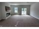 Bright living room features a modern fireplace with a wooden mantle and sliding glass doors to the deck at 564 Jocund St # 11, Rolesville, NC 27571