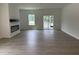 Open-concept living area with hardwood floors and fireplace at 564 Jocund St # 11, Rolesville, NC 27571