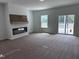 Spacious living room boasting a modern fireplace, large windows, and a sliding glass door for natural light at 564 Jocund St # 11, Rolesville, NC 27571