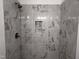Elegant tiled shower with a built-in niche and bronze fixtures, providing a spa-like experience at 564 Jocund St # 11, Rolesville, NC 27571