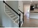 Elegant staircase with dark rails and white risers leads to the upper level, with a glimpse of the modern kitchen at 564 Jocund St # 11, Rolesville, NC 27571