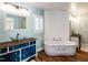 Modern bathroom featuring a soaking tub, vessel sinks, and stylish wood accents at 5715 Sky Lane Dr, Durham, NC 27704