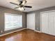 Bedroom with hardwood floors, ceiling fan, and bright window views at 5715 Sky Lane Dr, Durham, NC 27704