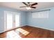 Spacious bedroom featuring a ceiling fan and access to the outside at 5715 Sky Lane Dr, Durham, NC 27704
