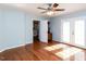 Bright bedroom featuring a ceiling fan and hardwood floors at 5715 Sky Lane Dr, Durham, NC 27704
