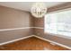 Dining room featuring unique light fixture, stylish trim, and hardwood flooring at 5715 Sky Lane Dr, Durham, NC 27704