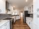Gourmet kitchen with white cabinets, subway tile backsplash, and stainless appliances at 5715 Sky Lane Dr, Durham, NC 27704