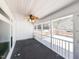 Relaxing screened-in porch with fan and views of the backyard and wooded area at 5715 Sky Lane Dr, Durham, NC 27704