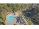 Aerial view showcasing a pool, tennis court, and recreation area in a wooded community at 700 Grandview Dr, Durham, NC 27703