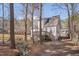The home's backyard boasts mature trees, a stream, and a deck for entertaining at 700 Grandview Dr, Durham, NC 27703