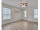 Bright bedroom featuring hardwood floors, neutral walls, and multiple windows at 700 Grandview Dr, Durham, NC 27703