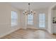 Bright dining room with chandelier, natural light, and doorway to kitchen at 700 Grandview Dr, Durham, NC 27703