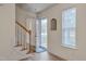 Bright foyer featuring hardwood floors, staircase, and natural light from the window at 700 Grandview Dr, Durham, NC 27703