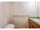 Small bathroom with single sink vanity and peeling wallpaper at 706 Collington Dr, Cary, NC 27511