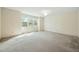 Bedroom featuring neutral walls, carpet, and a large window at 706 Collington Dr, Cary, NC 27511