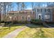 Exterior of townhomes featuring brick and siding with green grass lawns at 706 Collington Dr, Cary, NC 27511