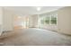 Spacious living room with large windows and carpet flooring, perfect for relaxation at 706 Collington Dr, Cary, NC 27511