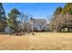Backyard view showing the house, utility shed, and large lawn at 716 S Meadow Rd, Raleigh, NC 27603