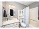 This bathroom features updated fixtures, vanity, mirror, and a shower/tub combo at 716 S Meadow Rd, Raleigh, NC 27603