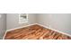 This bedroom offers natural light, neutral paint, and attractive wood flooring at 716 S Meadow Rd, Raleigh, NC 27603
