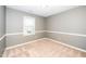 This bedroom has neutral carpeting, a window with blinds, and is freshly painted at 716 S Meadow Rd, Raleigh, NC 27603