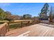 A backyard wooden deck with wooden railings overlooks a spacious yard at 716 S Meadow Rd, Raleigh, NC 27603