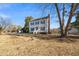 Charming two-story home with traditional architecture and mature trees on a sunny day at 716 S Meadow Rd, Raleigh, NC 27603