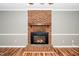 Close-up of the brick fireplace, a focal point in the living room with wood flooring at 716 S Meadow Rd, Raleigh, NC 27603