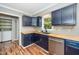 Kitchen featuring navy blue cabinets, butcher block countertops, and stainless steel appliances at 716 S Meadow Rd, Raleigh, NC 27603