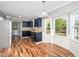 Bright eat-in kitchen with navy cabinets, butcher block countertops, and stainless steel appliances at 716 S Meadow Rd, Raleigh, NC 27603
