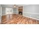 Cozy living room featuring a brick fireplace, wood flooring, and access to a deck at 716 S Meadow Rd, Raleigh, NC 27603