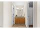 Bright bathroom with wood vanity, granite countertop, and tile flooring at 723 Renshaw Ct, Cary, NC 27518