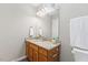 Updated bathroom with a granite vanity and a large framed mirror at 723 Renshaw Ct, Cary, NC 27518