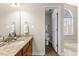 Bathroom with wood vanity, granite countertop, and walk-in shower at 723 Renshaw Ct, Cary, NC 27518