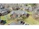 A bird's eye shot reveals a red brick condo building with mature trees and convenient parking spaces at 723 Renshaw Ct, Cary, NC 27518