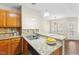 Bright eat-in kitchen with granite countertops, double sink, and modern light fixtures at 723 Renshaw Ct, Cary, NC 27518